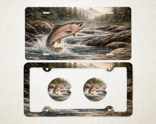 May include: A license plate and frame set featuring a leaping rainbow trout in a river scene. The artwork includes a mountain backdrop and forest, with matching car coasters. The design is detailed and colorful.